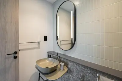 a bathroom with a sink and a mirror at Mystic - Luxe 1BR Apt with Burj Khalifa & Canal Views in Dubai