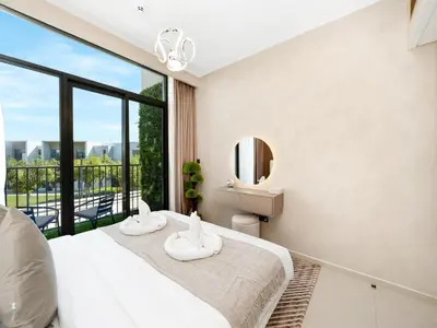 a bedroom with a bed and a large window at Luxury 4BR Villa in Arabian Ranches 3, Resort-Style Living with Private Garden & Hot Tub in Nadd Shubayḩ