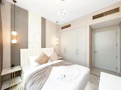 a bedroom with a white bed and a mirror at Luxury 4BR Villa in Arabian Ranches 3, Resort-Style Living with Private Garden & Hot Tub in Nadd Shubayḩ