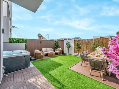 a backyard with a hot tub and grass at Luxury 4BR Villa in Arabian Ranches 3, Resort-Style Living with Private Garden & Hot Tub in Nadd Shubayḩ