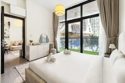 a bedroom with a large bed with two stuffed animals on it at Modern 1BR Apartment in DAMAC Merano Business Bay in Dubai