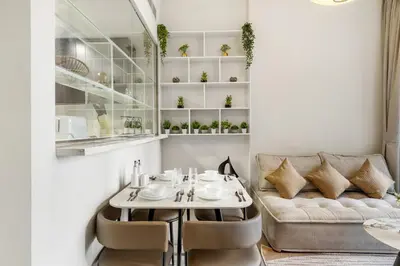 a living room with a table and a couch at Modern 1BR Apartment in DAMAC Merano Business Bay in Dubai