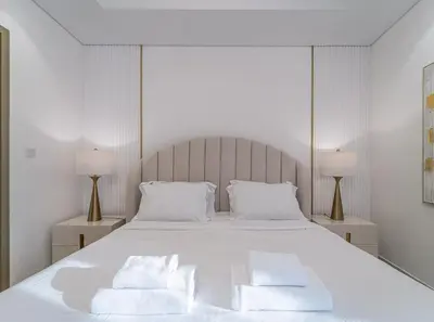 a bedroom with a white bed with two pillows at Luxury 1BR High floor Paramount Midtown in Dubai