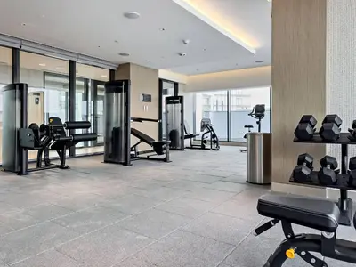 a gym with treadmills and exercise equipment in a building at Premium 3BR Study in Sobha Hartland in Dubai