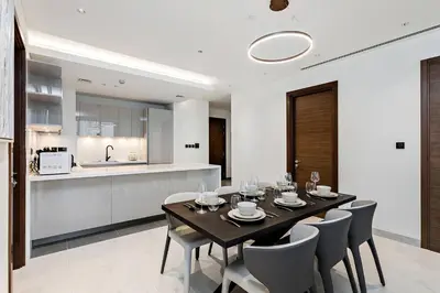 a dining room and kitchen with a table and chairs at Premium 3BR Study in Sobha Hartland in Dubai