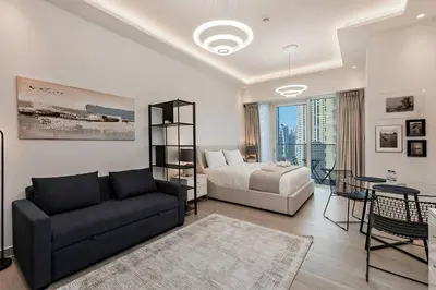 a living room with a couch and a bed at Chic Studio in Me Do Re JLT YOLO in Dubai