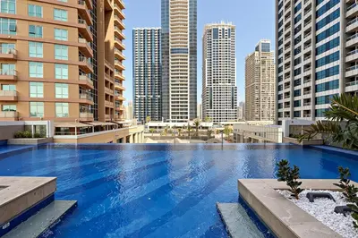 a large swimming pool in a city with tall buildings at Chic Studio in Me Do Re JLT YOLO in Dubai
