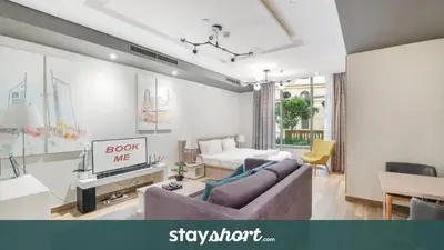 a living room with a couch and a table at StayShort - Cozy Relaxing Studio in JBR - Walk to the Beach in Dubai