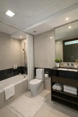 a bathroom with a tub and a toilet and a sink at Downtown Three Beds near to Burj Khalifa and Dubai Mall in Dubai