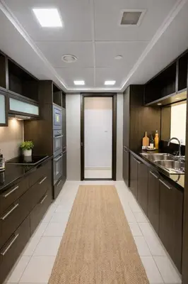 a kitchen with dark wood cabinets and a white tile floor at Downtown Three Beds near to Burj Khalifa and Dubai Mall in Dubai