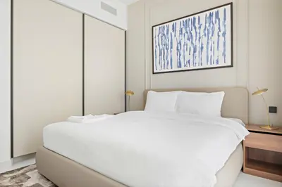 a white bedroom with a large white bed at Silkhaus 1BDR in Marina Vista Tower Private Beach in Dubai