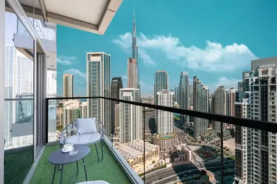a balcony with a chair and a view of the city at Restay Homes at Paramount Midtown Hotel - Infinity pool access included in Dubai