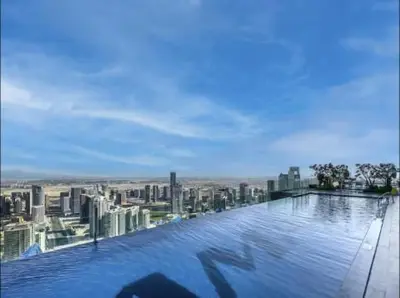 a view of a city from a swimming pool at Restay Homes at Paramount Midtown Hotel - Infinity pool access included in Dubai