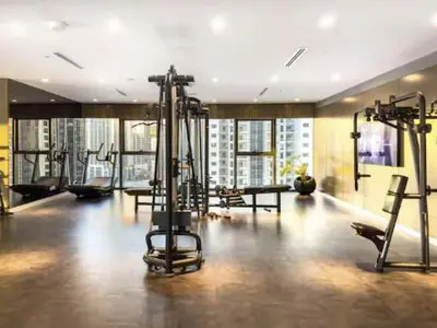 a gym with several tread machines in a large room at Restay Homes at Paramount Midtown Hotel - Infinity pool access included in Dubai