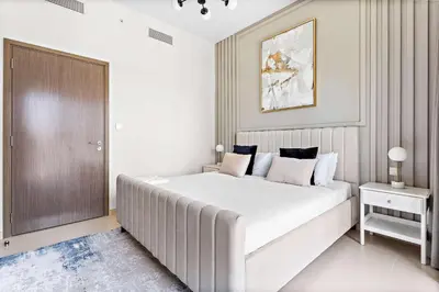 a white bedroom with a large bed in it at Silkhaus Prime 1BDR in Burj Royale in Dubai