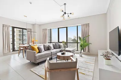 a living room with a couch and a table at Silkhaus 1 BDR in South Ridge on High Floor in Dubai