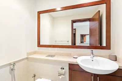 a bathroom with a sink and a mirror at Silkhaus 1 BDR in South Ridge on High Floor in Dubai
