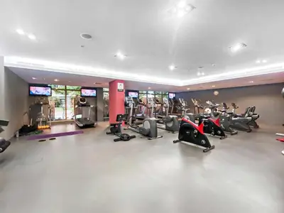a gym with several treadmills and cardio machines at Silkhaus 1 BDR in South Ridge on High Floor in Dubai