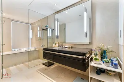 a bathroom with a sink and a glass shower at Luxury 1 Bed in Marina Mall JW Marriot in Dubai