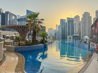 a large swimming pool in a city with tall buildings at Luxury 1 Bed in Marina Mall JW Marriot in Dubai