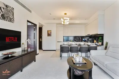 a living room with a couch and a kitchen at Luxury 1 Bed in Marina Mall JW Marriot in Dubai