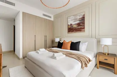 a white bedroom with a large white bed with pillows at Silkhaus Spacious 3BDR & Maid Tilal Al Ghaf in Dubai