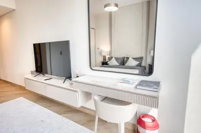 a bedroom with a mirror and a bed at Upscale Modern 2-Bedroom with Elegant Interiors in Dubai
