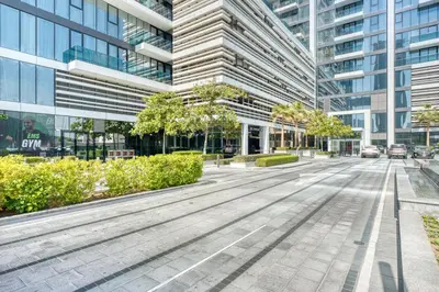 an empty street in front of a tall building at Upscale Modern 2-Bedroom with Elegant Interiors in Dubai