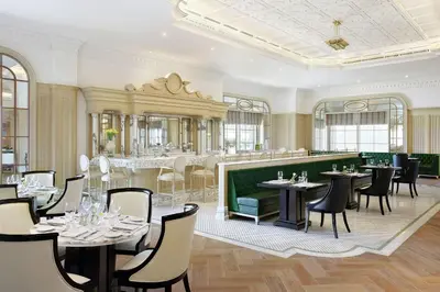 a restaurant with tables and chairs and a bar at Al Habtoor Palace - Preferred Hotels & Resorts in Dubai