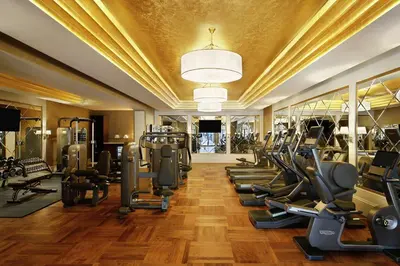 a gym with a row of treadmills and ellipticals at Al Habtoor Palace - Preferred Hotels & Resorts in Dubai