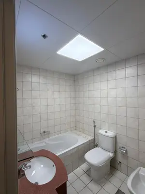 a bathroom with a tub and a toilet and a sink at 403,1 BHK lake View, V3 tower, JLT Royal Montania in Dubai