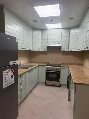 a kitchen with white cabinets and a stove top oven at 403,1 BHK lake View, V3 tower, JLT Royal Montania in Dubai