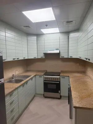 a kitchen with white cabinets and a stove top oven at 403,1 BHK lake View, V3 tower, JLT Royal Montania in Dubai