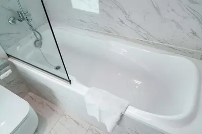 a bathroom with a white tub and a toilet at StayShort - Stlylish 2 Bedroom in Dubai Marina that Sleeps 4 Near Metro in Dubai