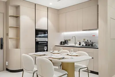 a dining room with a table and chairs in a kitchen at FIRST CLASS 1BR Pearl House Elegance in Dubai