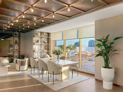 a dining room with a table and chairs in a room at FIRST CLASS 1BR Pearl House Elegance in Dubai