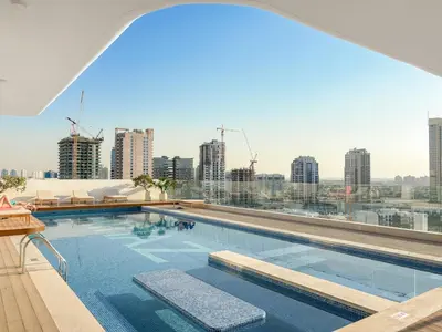 a swimming pool with a view of a city skyline at FIRST CLASS 1BR Pearl House Elegance in Dubai