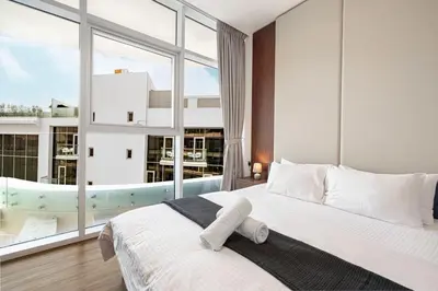 a bedroom with a large bed and a large window at Palm Jumeirah Luxury Direct Beach Access and Views in Dubai