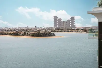 a large body of water with a city in the background at Palm Jumeirah Luxury Direct Beach Access and Views in Dubai
