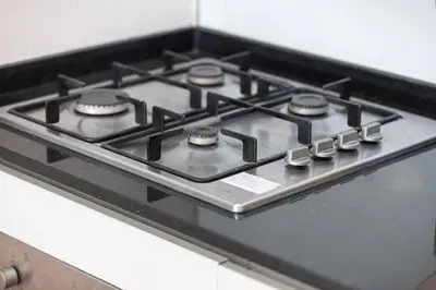 a stove top oven with four burners on it at Palm Jumeirah Luxury Direct Beach Access and Views in Dubai