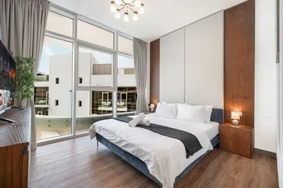 a bedroom with a large bed and a large window at Palm Jumeirah Luxury Direct Beach Access and Views in Dubai