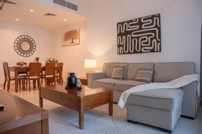 a living room with a couch and a table at Stylish 1BR close to Metro and Dubai Marina in Dubai