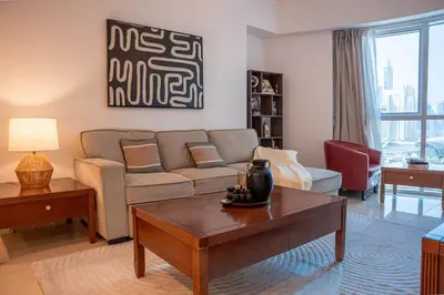 a living room with a couch and a coffee table at Stylish 1BR close to Metro and Dubai Marina in Dubai