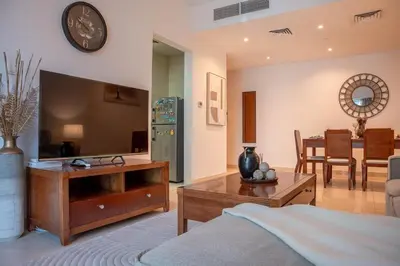a living room with a bed and a tv at Stylish 1BR close to Metro and Dubai Marina in Dubai