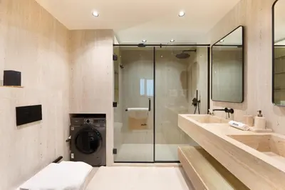 a bathroom with a washer and dryer in it at Modern and Stylish 2-BR High Floor All Bills Included in Dubai