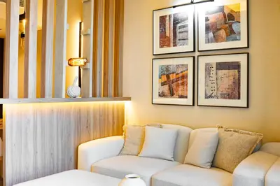 a living room with a couch and pictures on the wall at Modern and Stylish 2-BR High Floor All Bills Included in Dubai