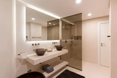 a bathroom with two sinks and a shower at Modern & Bright 2 Bedroom Apartment at The Palm in Dubai