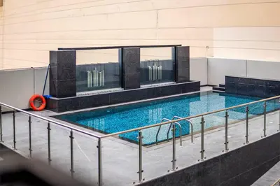 a large swimming pool with an orange float in it at Vogue JVC Al Serh Residences Near Circle Mall, One Bedroom Plus Maid's room Apartment with Balcony and City View, Access to all Amenities in Dubai
