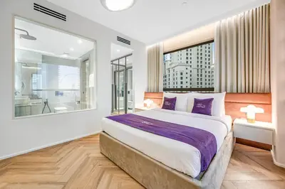 a bedroom with a large bed and a large window at Modern 1BR JBR Stunning Sea & Ain Dubai Views in Dubai