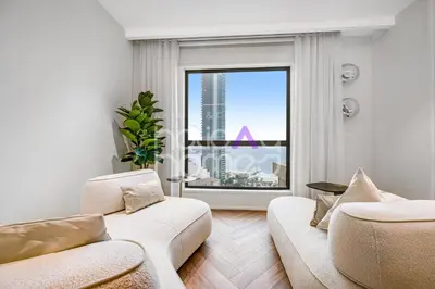 a living room with two white couches and a large window at Modern 1BR JBR Stunning Sea & Ain Dubai Views in Dubai